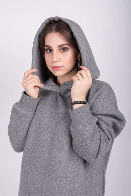 Premium Photo Young Girl In A Gray Sweatshirt With A Hood On Her Head