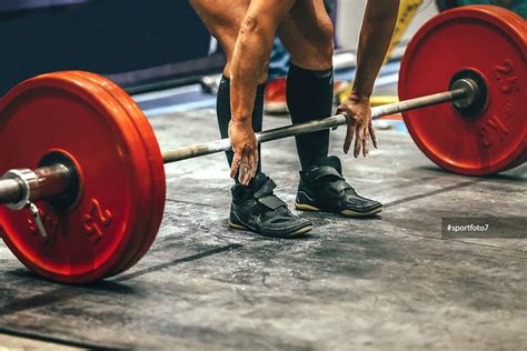 Male Powerlifter Preparing For Deadlift Of Barbell During Competition