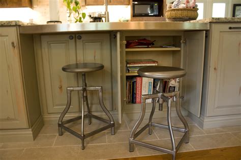 Narrow kitchen cabinet command center added to end of a bank of cabinets broom and mop storage. 12" deep cabinets were added under the seating area for ...