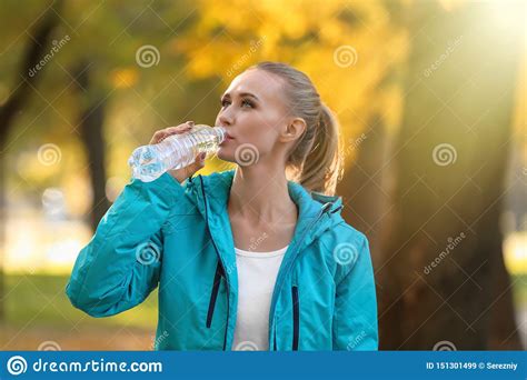Sporty Young Woman Drinking Water In Autumn Park Stock Image Image Of