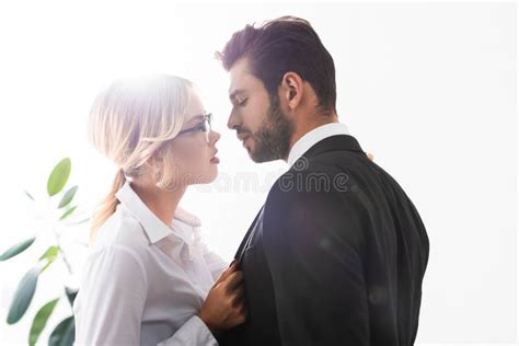 Side View Of Businessman And Businesswoman Looking At Each Other While