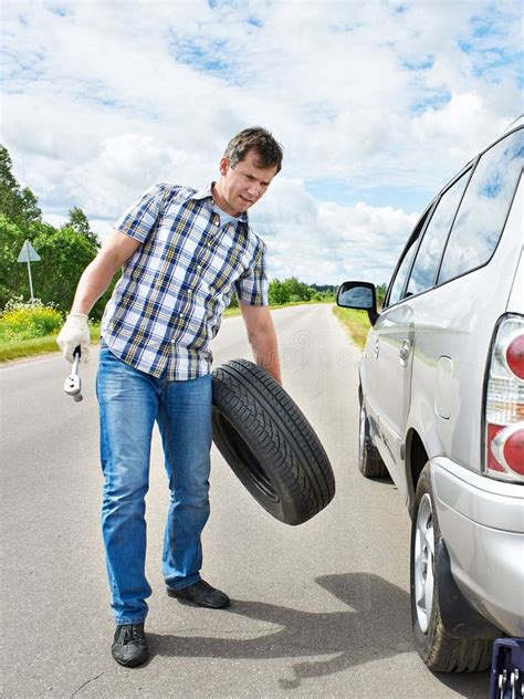 Man Changing A Spare Tire Of Car Stock Photo Image Of Help Road