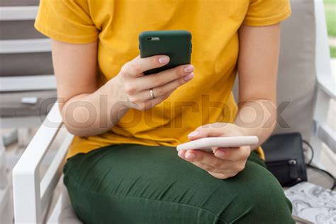 Female Hands With Two Mobile Phones Busy Concept Stock Image Colourbox