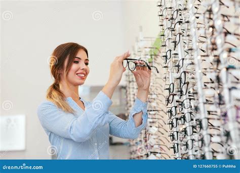 optical shop woman near showcase looking for eyeglasses stock image image of female