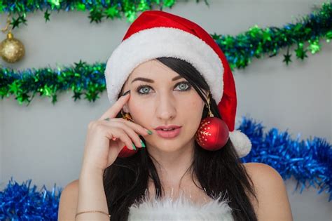 Premium Photo Santas Sexy Helper Passionate Brunette In Elf Costume