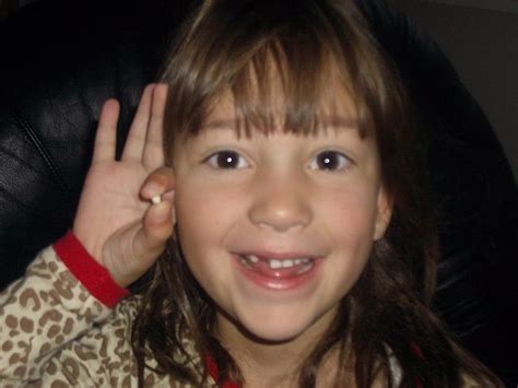 Filesmiling Girl Holding Up Baby Tooth Wikimedia Commons
