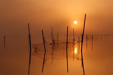 Black Rods On Body Of Water During Sunset Hd Wallpaper Wallpaper Flare