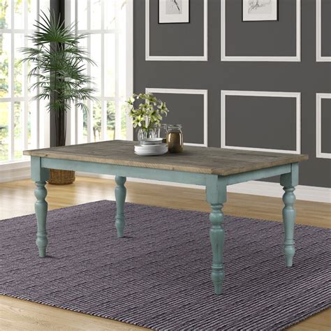Combining a weathered antique blue and coffee finish with intricately carved legs, the table is elegant and rustic at once. Ophelia & Co. Cierra Two-Tone Dining Table | Wayfair