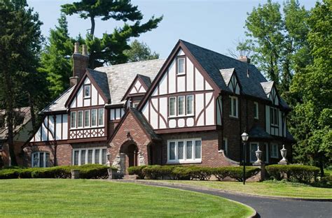 Stunning Tudor Revival Style Home With Red Brick Lower Exterior Topped