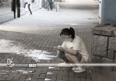 woman plays with mobile phone while urinating in public on sai wan ho street dimsum daily