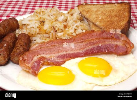 Breakfast Plate With Eggs Sunny Side Up Bacon Link Sausage Hash
