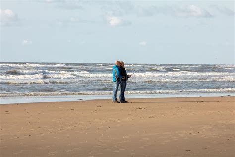 A Woman And A Man Are Walking On A Sunny Day Along The Beach In Katwijk Netherlands Editorial