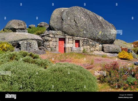 Portugal Curious Stone House Under A Huge Rock In The Typical Stock