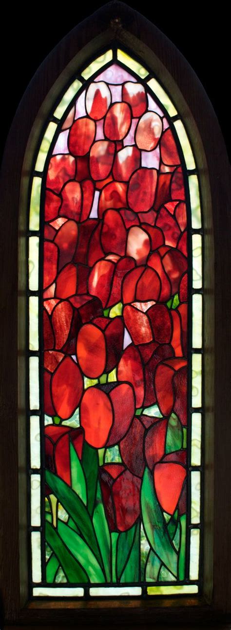 A Stained Glass Window With Red Flowers In It