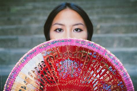 Young Asian Woman Hiding Behind A Traditional Chinese Fan Del