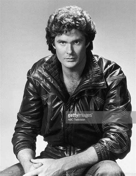 A Black And White Photo Of A Man In A Leather Jacket Sitting On The Ground