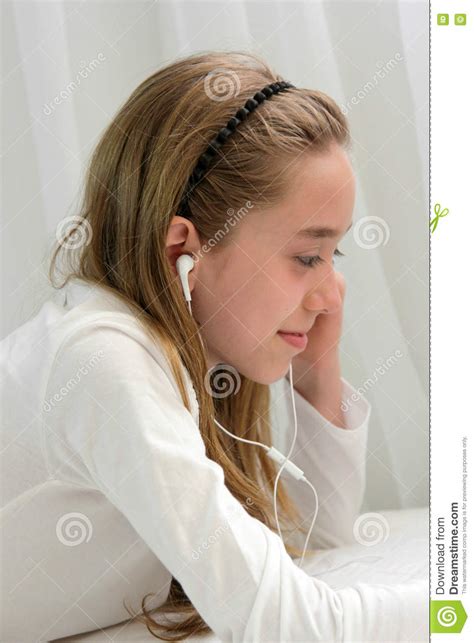 Teenager Girl Wearing Earphone Playing On Tablet Stock Image Image Of