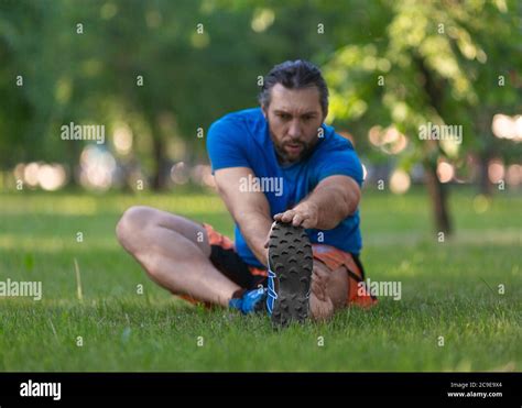 man stretching after jogging the concept of an active lifestyle and healthy lifestyle in age