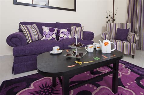 Adding to the allure, a painting of a forest exhibits dreamy oranges, greens, and lavender. Design with Purple
