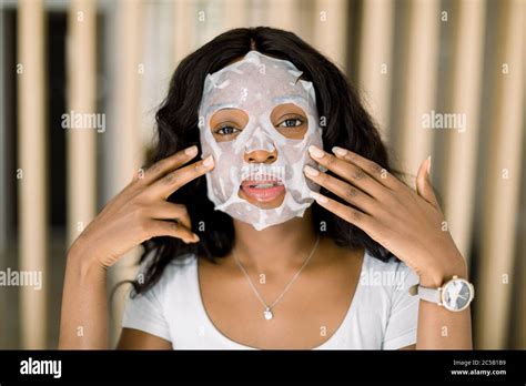 Beauty Skin Care Concept Beautiful African Woman Applying Paper Sheet