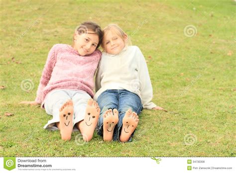 Girls With Smileys On Toes And Soles Stock Photo Image Of Enjoy Four