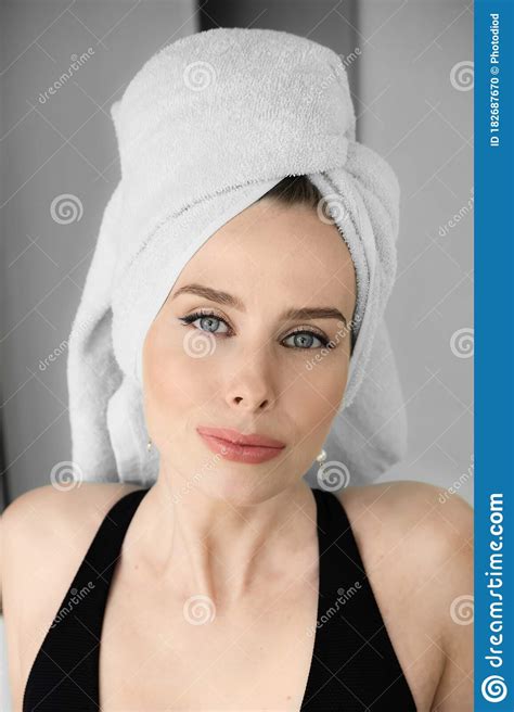 Beauty Portrait Of A Cheerful Attractive Woman With A Towel On Her Head And Looking At Camera