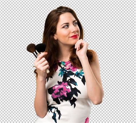 Premium Psd Happy Beautiful Young Girl With Makeup Brush Thinking