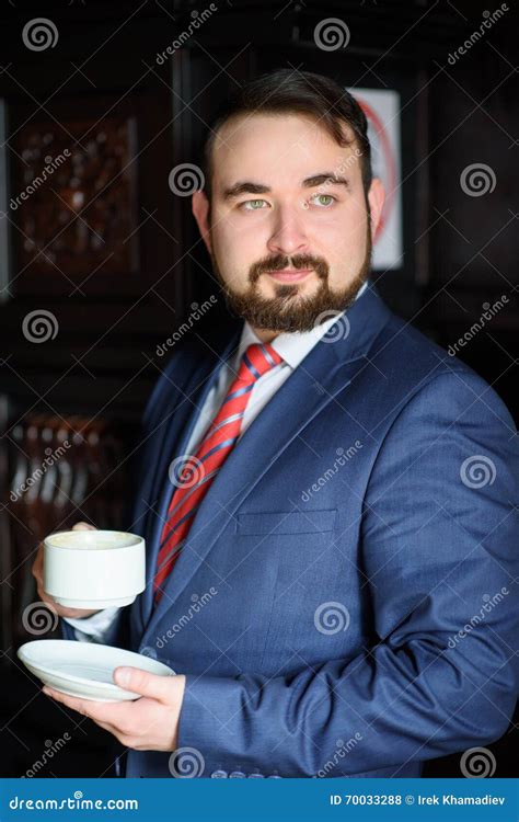 Rich Successful Handsome Man In A Suit Drinking Coffee Stock Photo
