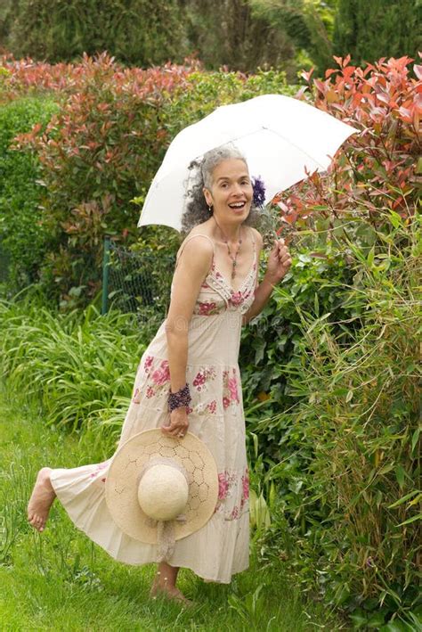 Retro Mature Woman Laughing In Garden With Umbrella Stock Image Image