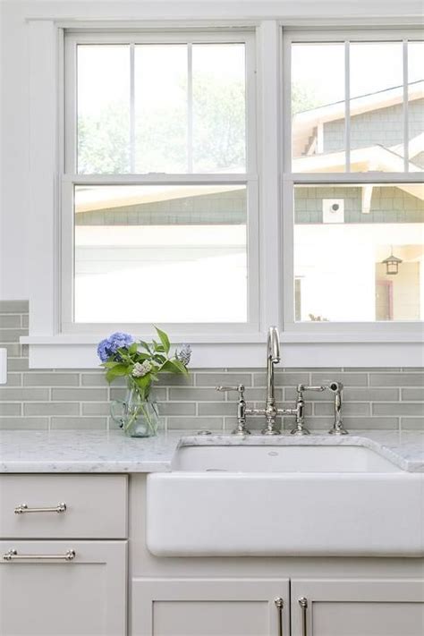 The kitchen has a pretty country feel with light mint green paint. Light gray shaker cabinets in a transitional kitchen ...