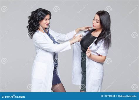 Female Doctor Examining Another Woman With Stethoscope Stock Photo