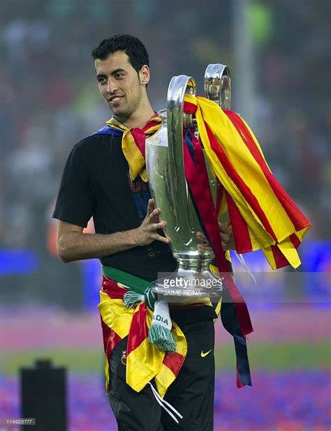 Barcelonas Sergio Busquets Holds The Champions League Trophy During