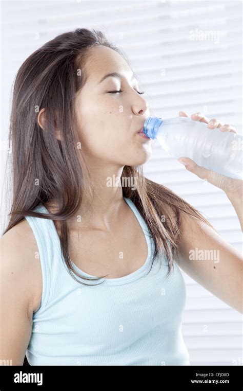 Young Woman Drinking Bottled Water Stock Photo Alamy