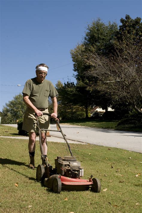 Mowing Grass Free Stock Photo A Man Mowing A Lawn 15236