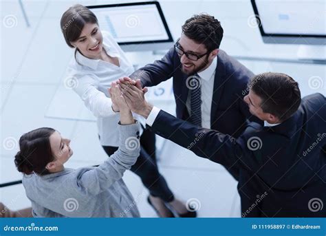 Successful Business Team Giving Each Other A High Five Standing In The