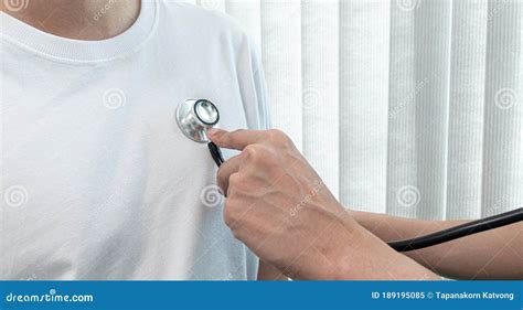 Doctor Using Sphygmomanometer With Stethoscope To Check The Heart Rate