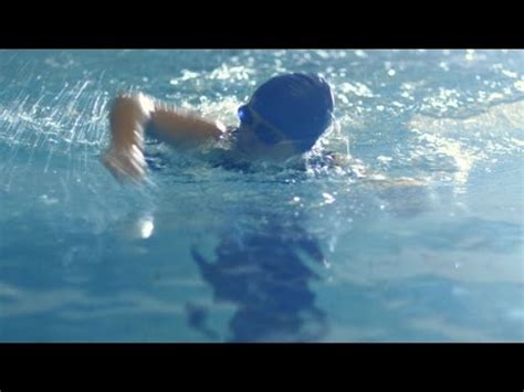 Female Swimmer Performing Front Crawl During In Swimming Pool Stock