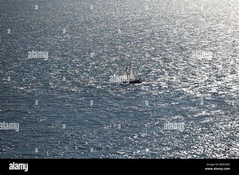 Aerial View Of A Sailing Yacht At Full Sail At Sea With The Sun