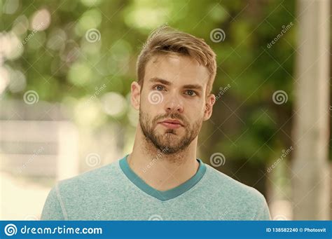 man with bristle on calm face nature background defocused man with beard or unshaven guy