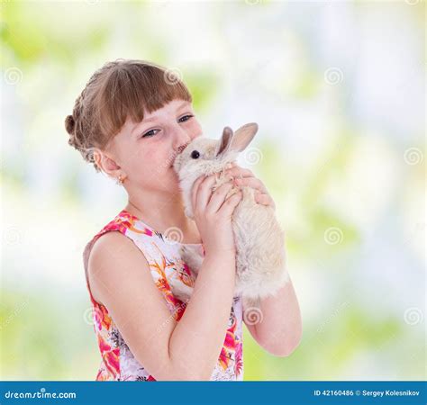 Girl kissing a rabbit stock photo. Image of looking, nursing - 42160486