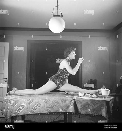 woman of the 1940s a woman is seen practising gymnastics while having a cup of coffee she
