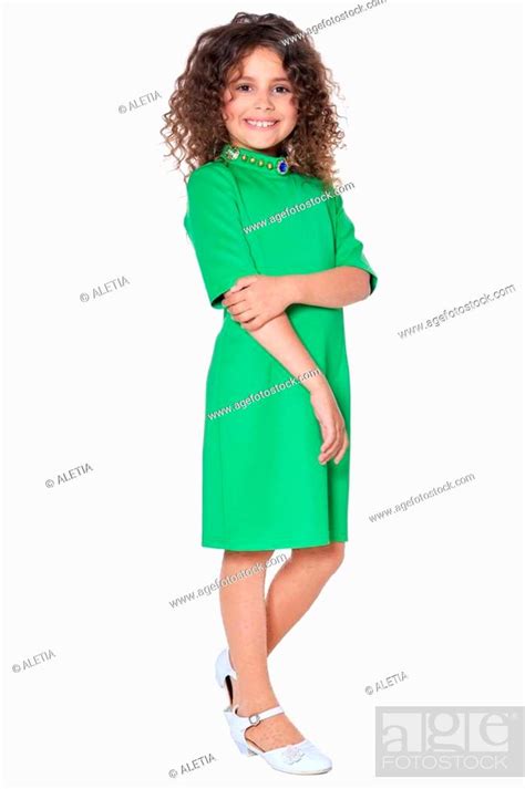 Portrait Of Cute Little Girl Posing In Green Dress Stock Photo