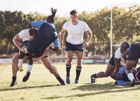 Rugby Sports And Men Tackle For Ball On Field For Match Practice And
