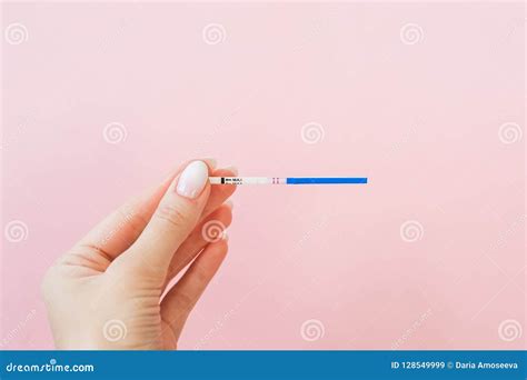 Pregnancy Test In Female Hand On Pink Background Positive Resultn