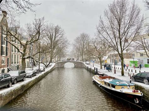 snow and frozen canals in amsterdam winter 2021 velvet escape