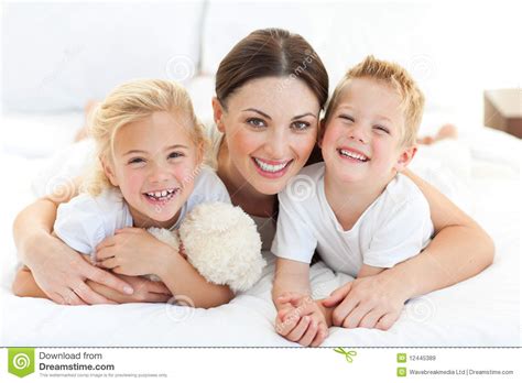 Happy Mother And Her Children Lying On A Bed Stock Image Image Of