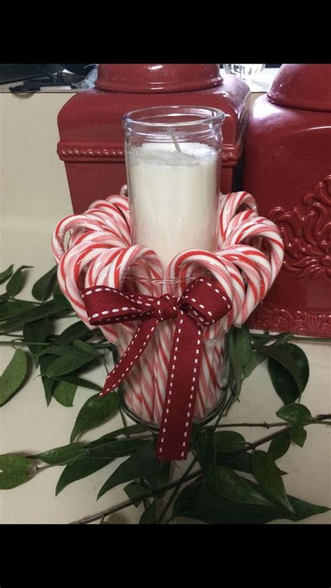 A Glass Jar Filled With White And Red Candy Canes