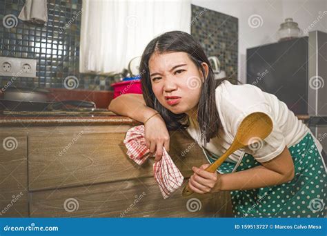 Young Tired And Stressed Asian Chinese Woman In Cook Apron Working