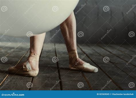 Tensed Ballet Dancer Legs Located In The Black Colored Room Stock Image