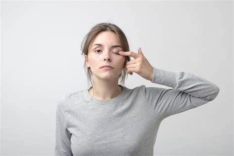 The Woman Is Touching Her Eye To Show That She Has Problem With